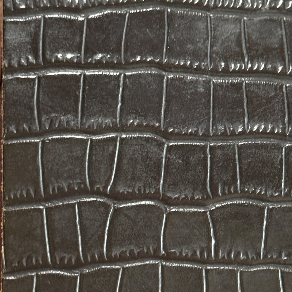 Name: Bamboo-Grain Embossed Genuine Leather
Material: Top-grain cowhide; PU or microfiber bases may also be available depending on product specifications
Reference Thickness: Approximately 1.2–1.6 mm; customizable to suit product design

The bamboo-grain texture features a regular, embossed square pattern inspired by the look of crocodile belly scales. It adds definition and a refined appearance to leather goods. “Crocodile-inspired” describes the surface pattern only; it does not mean the material is made from crocodile skin.
This material typically has a medium-to-firm feel, making it suitable for products that benefit from shape retention and structure. Its surface coating can support everyday cleaning and surface protection. Common applications include phone cases, tablet covers, cardholders, small wallets and leather details for phone straps. Actual hand feel, gloss, abrasion resistance and stain resistance may vary with the base material, coating and product construction.