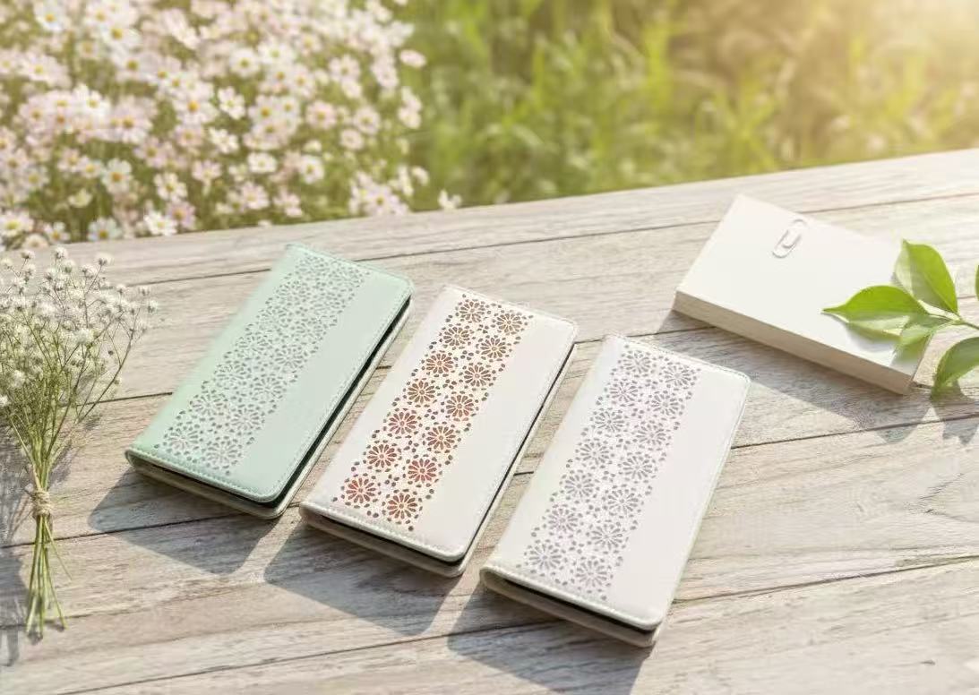 Floral cut‑out leather case with elegant layered detailing, Contrasting color floral pattern showing refined craftsmanship, Phone case in foldable stand mode for hands‑free viewing, Interior card slots for essential daily card storage, Slim wallet‑style l